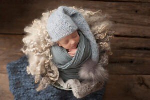 baby twins photographer Sussex newborn boy asleep knits wraps layers bobble hat studio portrait Samphire Photography
