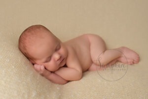 newborn baby photographs Sussex sleeping girl yellow studio portraits by Samphire Photography