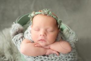 newborn baby photographs Sussex floral headband green knit studio portraits by Samphire Photography