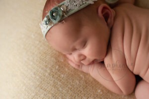 newborn baby photographs Sussex floral headband green yellow studio portraits by Samphire Photography