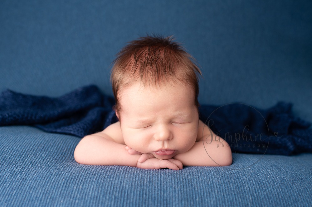 Experienced newborn photographer West Sussex sleeping baby boy blue studio portrait Samphire Photography