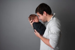 Experienced newborn photographer West Sussex father baby boy studio portrait Samphire Photography