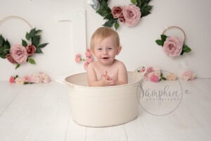 little girl having fun in a matel bath tub