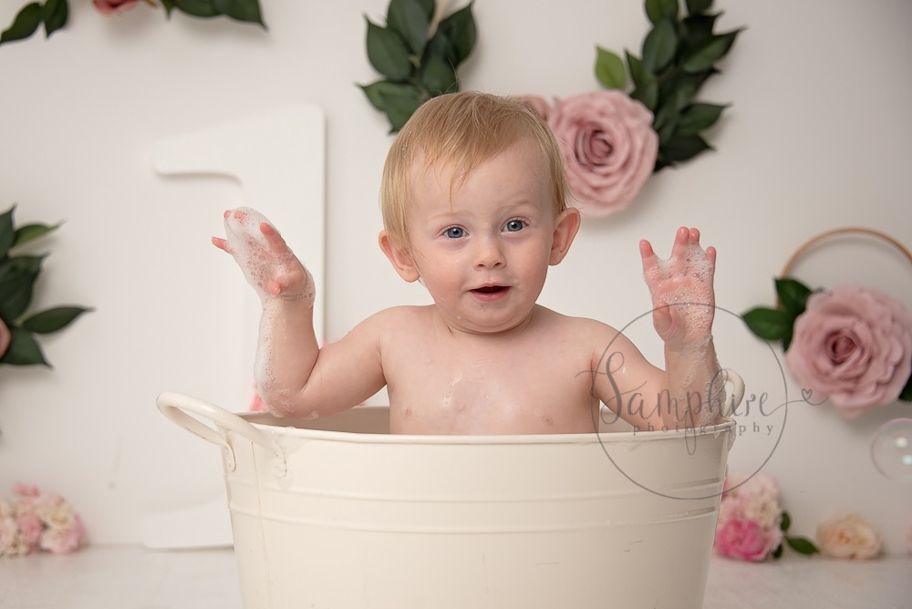 Baby's first year cake smash portraits pink floral bathtime Samphire Photography Sussex