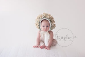 Baby's first year milestone portraits cream floral bonnet Samphire Photography Sussex