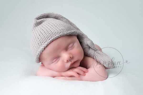 Newborn baby photographer boy wearing grey knitted hat in Sussex Samphire Photography