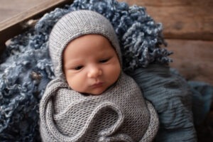 baby boy awake grey blue bonnet Newborn Photography West Sussex Samphire Photography