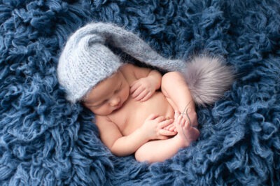 baby boy asleep blue flokati knitted hat Newborn Photography West Sussex Samphire Photography