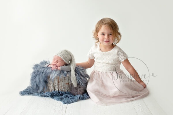 Newborn photographs with older sibling blue grey studio portrait Samphire Photography Sussex