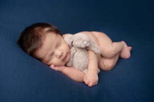 New baby portraits West Sussex blue background bunny Samphire Photography