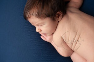 New baby portraits West Sussex blue background Samphire Photography
