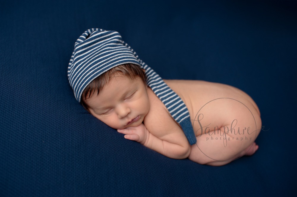 New baby portraits West Sussex hat blue background Samphire Photography