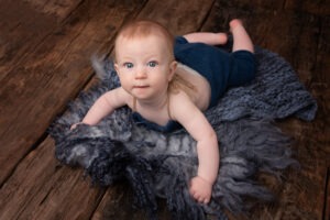 baby photoshoot horsham showing cute baby boy in blue romer
