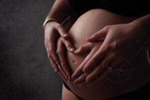 hands on pregnant belly portrait by West Sussex Photographer