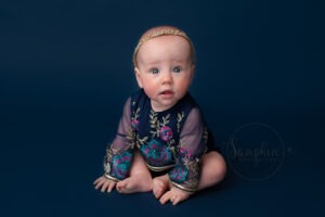 gorgeous girl on blue taken by experience baby photographer horsham
