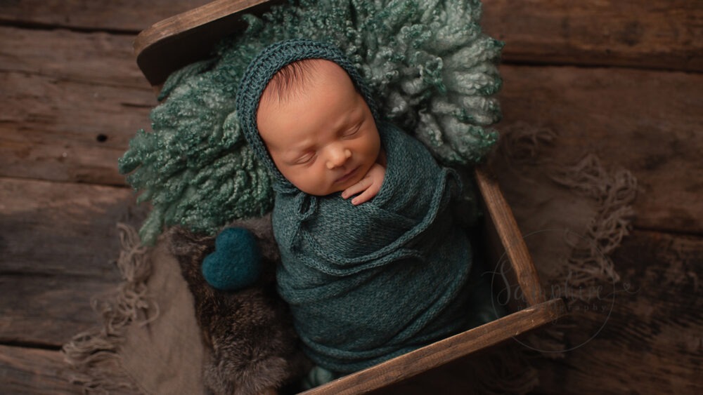 sleeping Newborn wrapped in green by Newborn photograph Horsham Samphire Photography Sussex