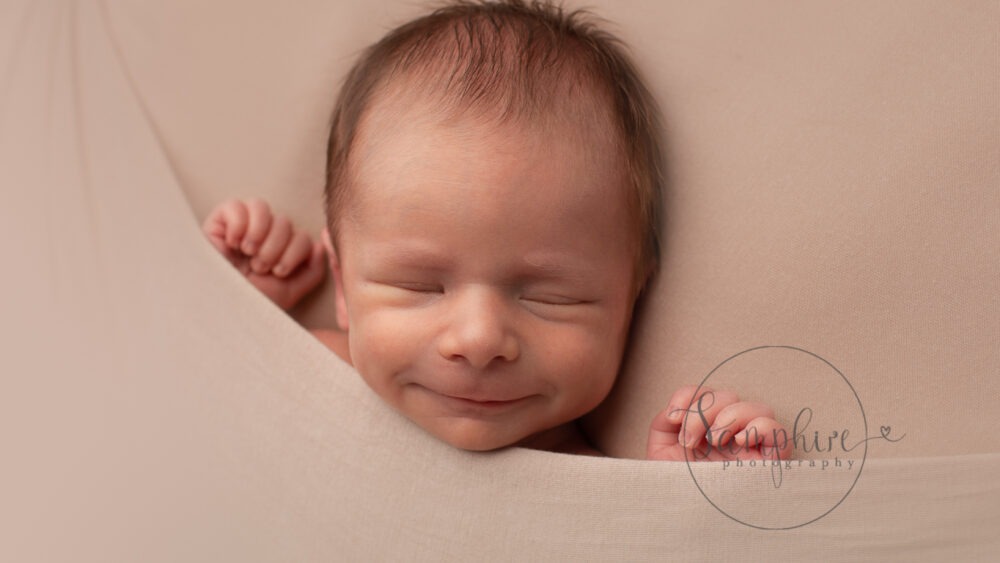 photograph your newborn baby at home smile Samphire Photography Sussex