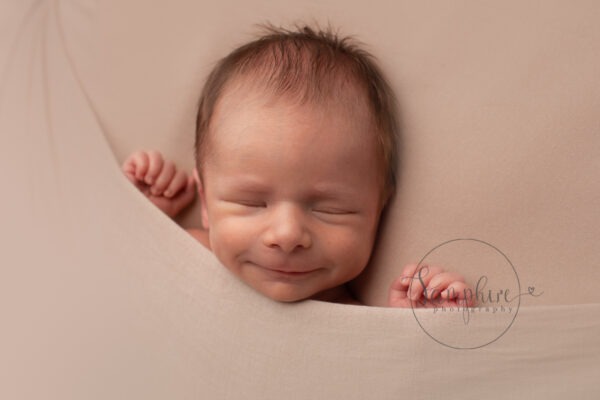photograph your newborn baby at home smile Samphire Photography Sussex