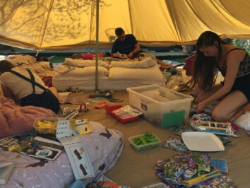 people doing craft activities in a tent