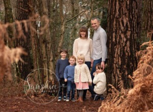 happy family smiling in autumn photoshoot on location in sussex
