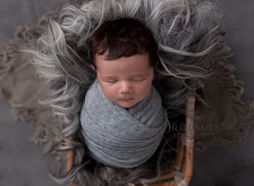 baby boy with full head of hair at his newborn session