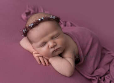 newborn baby girl in a relaxed pose
