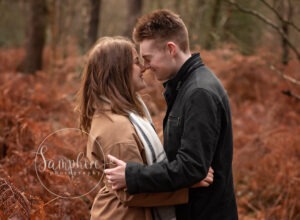 happy couple embrace in autumn woodland