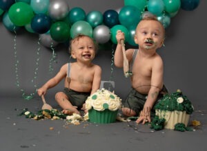 twin boys covered in green and cream cake in Horsham