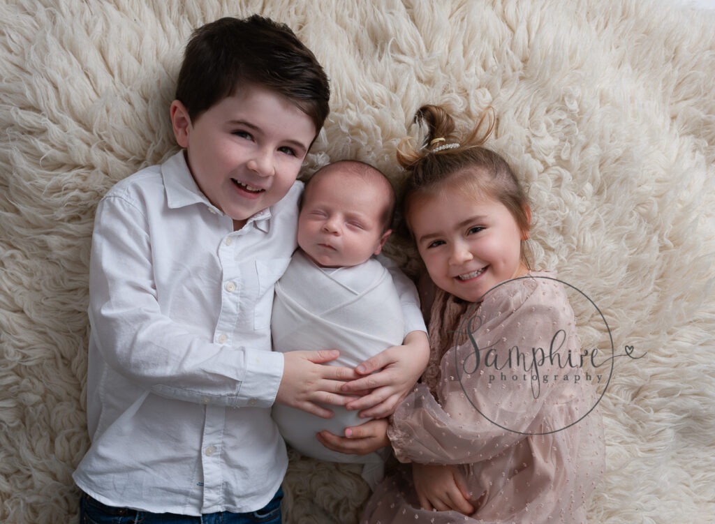 siblings with new baby newborn photographer Dorking