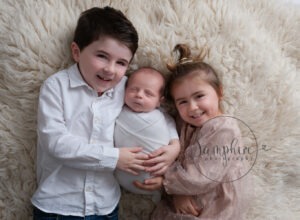 siblings with new baby newborn photographer Dorking
