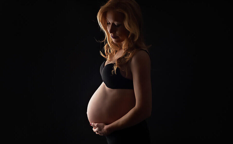 pregnant woman showing why maternity photographs important