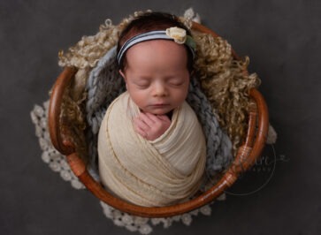 baby girl asleep wearing pretty floral headband by newborn photographer Dorking