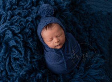 newborn boy asleep on blue flokati newborn photoshoot Horsham