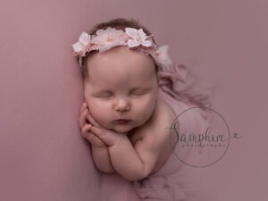 baby girl asleep wearing pretty pink headband