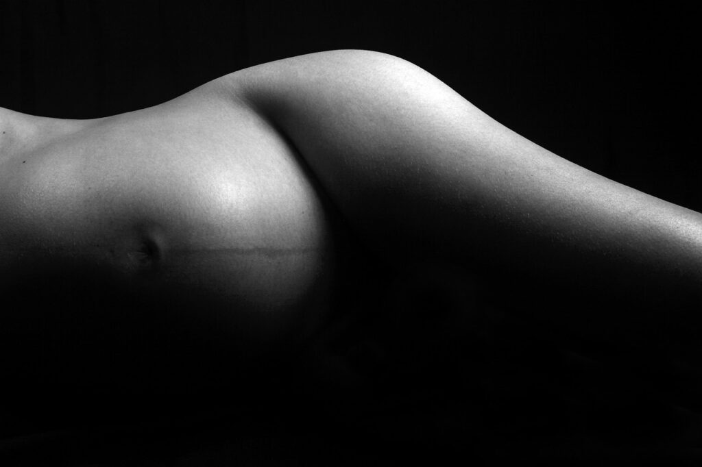 black and white photo of pregnant woman showing body changes during pregnancy