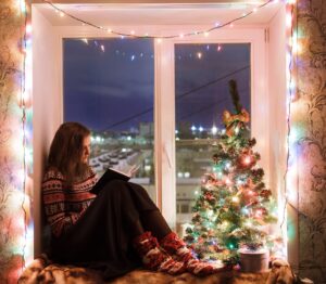 reading book with Christmas lights photo