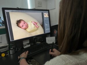 editing at a computer screen with samphire photography