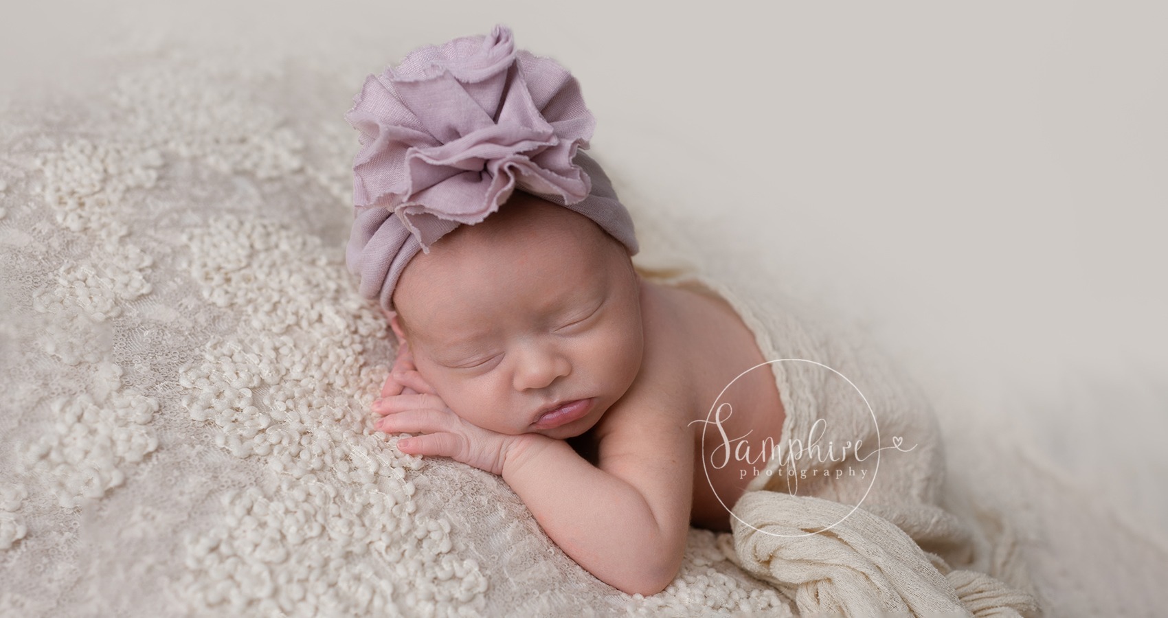 baby girl photographed at newborn photoshoot by Horsham photographer in sussex with a pink hat