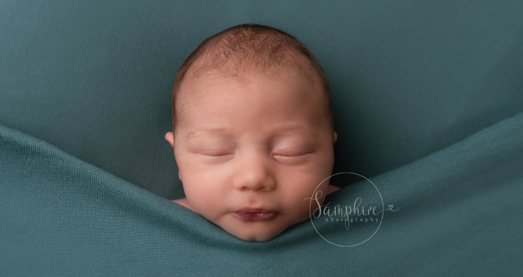 baby boy with pouting lips at a newborn photoshoot with Horsham photographer