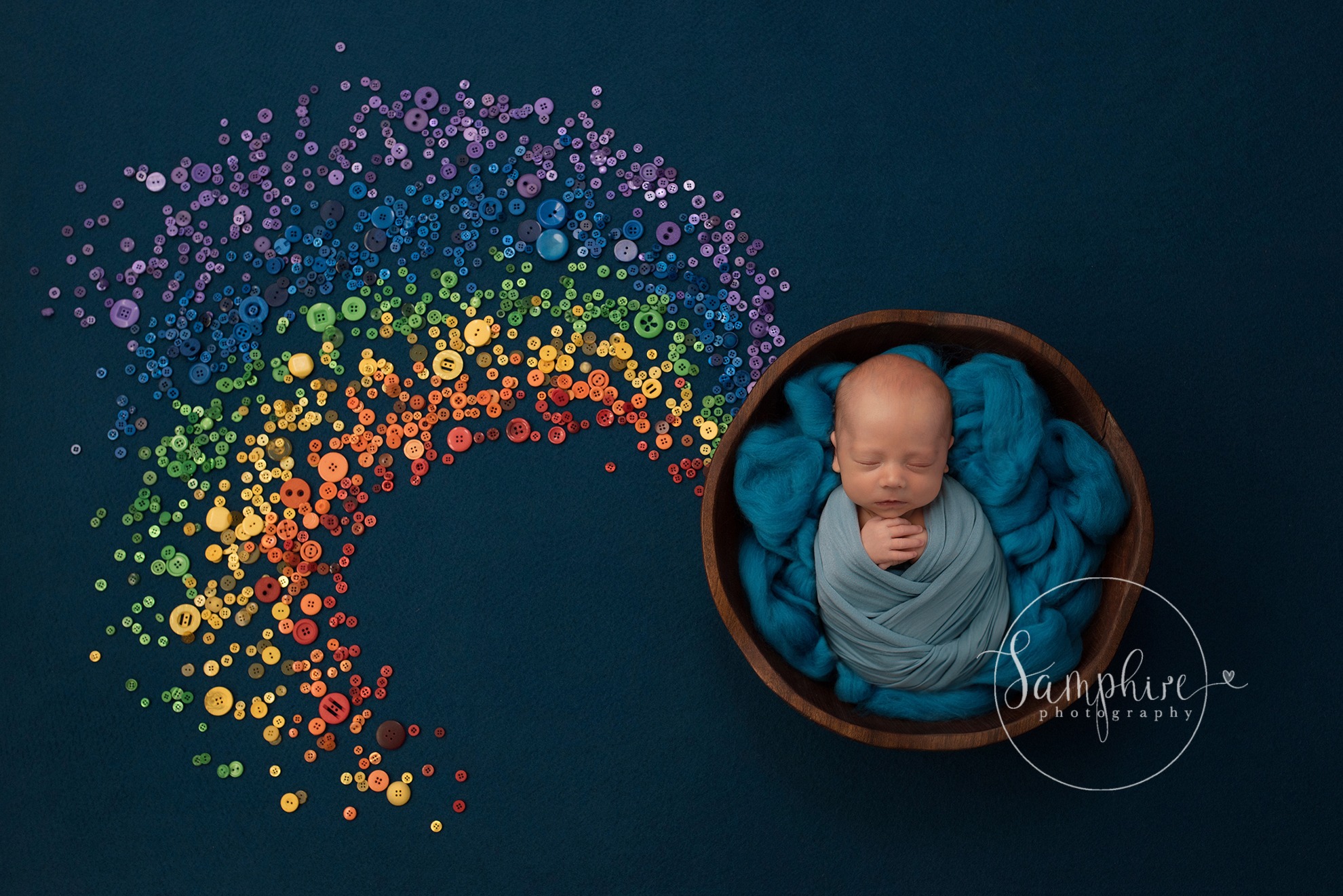 newborn baby with digital rainbow backdrop 