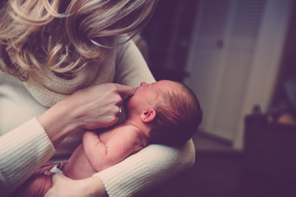 woman comforting newborn baby