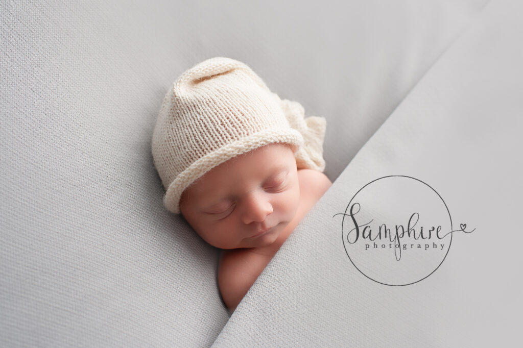 baby asleep wearing cream knitted hat newborn photographer Shoreham