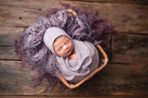 newborn studio portrait with purple props